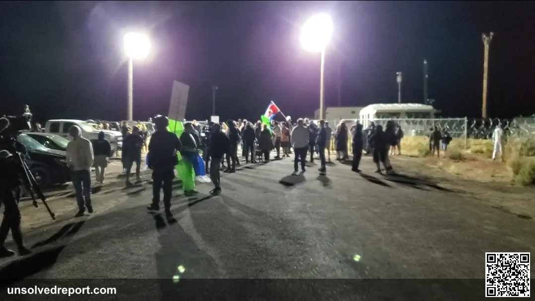 Satirical protesters gather in a crowd at the back entrance to Area 51 on the night of the Raid